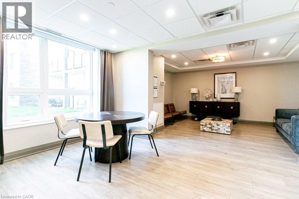 Open-concept common area featuring wood-finish flooring, recessed lighting, and large windows - 101 Shoreview Place Unit# 631, Stoney Creek, ON - Indoor Photo Showing Dining Room