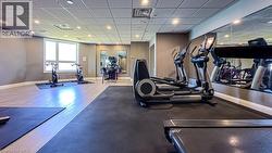 Spacious fitness area featuring recessed lighting, a drop-ceiling, and multiple large windows -