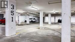 Underground parking garage featuring concrete pillars with identification numbers -