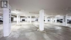 Underground parking facility featuring concrete flooring and structural pillars -