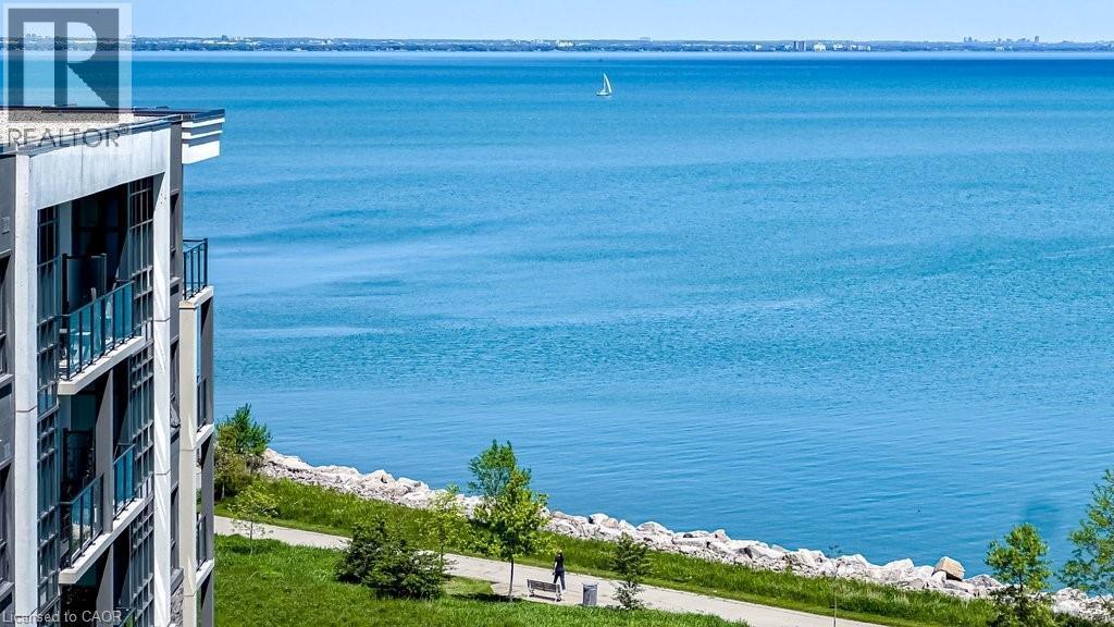 Contemporary building facade featuring multiple balconies with glass railings - 101 Shoreview Place Unit# 631, Stoney Creek, ON - Outdoor With Body Of Water With View