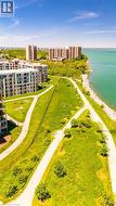 Aerial perspective showcasing contemporary multi-story buildings, expansive green spaces, and a prominent waterfront -