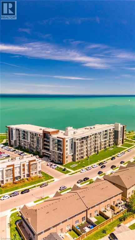 Waterfront multi-story residential building with private balconies and expansive windows - 101 Shoreview Place Unit# 631, Stoney Creek, ON - Outdoor With Body Of Water With View