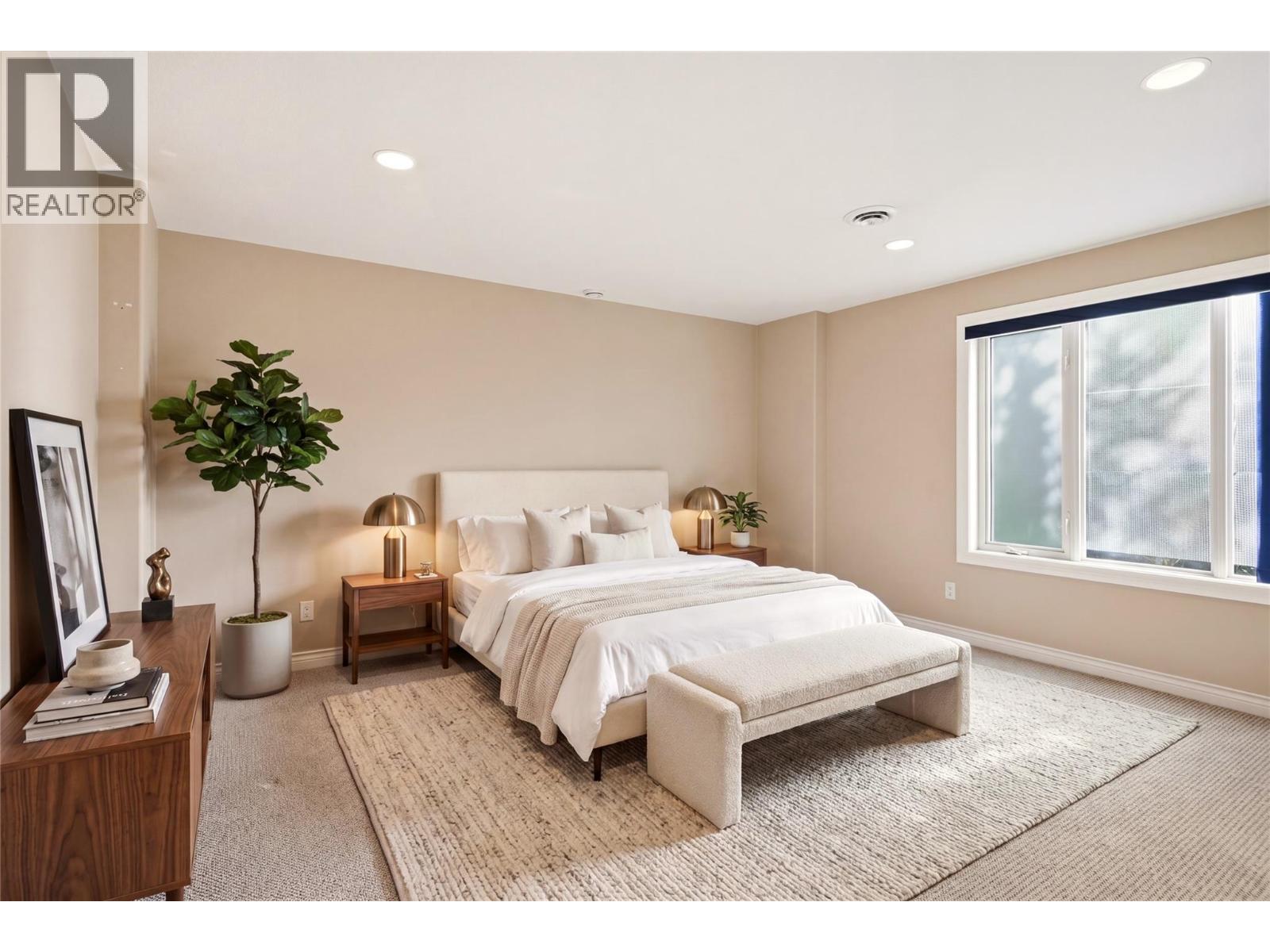 Lower level bedroom 2 with virtually staged furniture - 448 Viewcrest Road, Kelowna, BC - Indoor Photo Showing Bedroom
