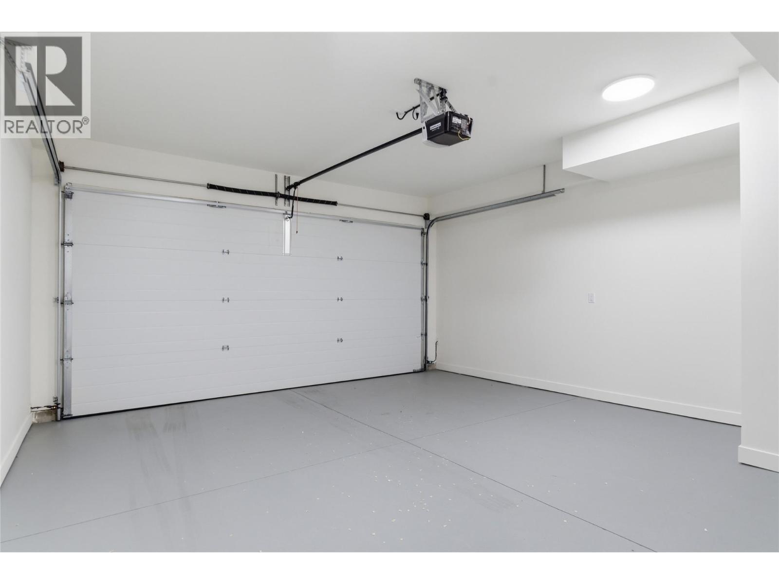 Attached double garage - 4601 97 Street Unit# 6, Osoyoos, BC - Indoor Photo Showing Garage