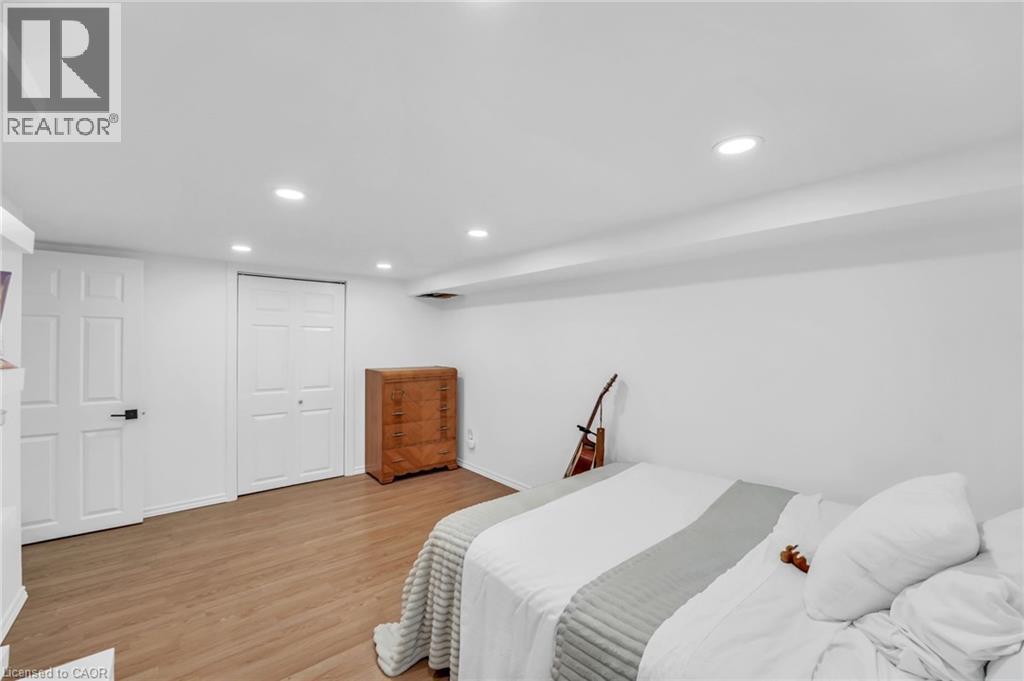 Room featuring light wood-finish flooring, white painted walls, and recessed lighting - 25 Park Street E, Hamilton, ON - Indoor Photo Showing Bedroom