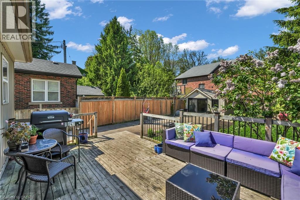 Expansive wood deck with a built-in railing, offering multiple seating areas - 25 Park Street E, Hamilton, ON - Outdoor With Deck Patio Veranda