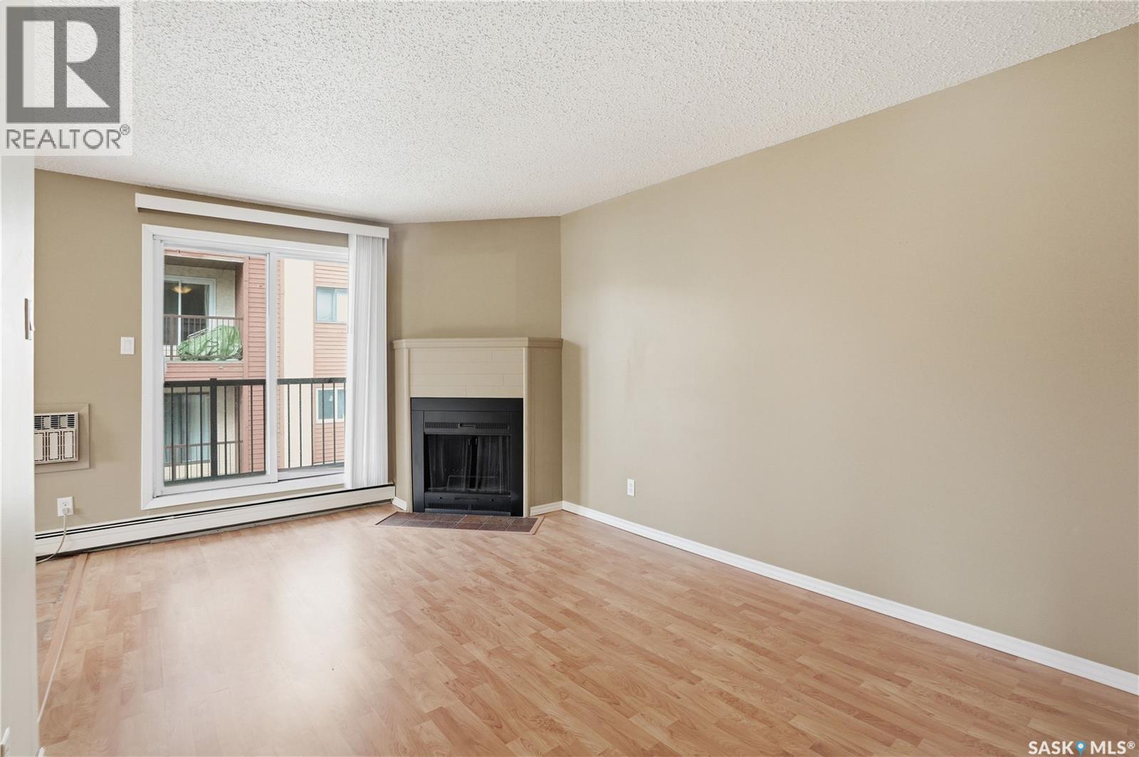 208B 4040 8Th Street E, Saskatoon, SK - Indoor Photo Showing Living Room With Fireplace
