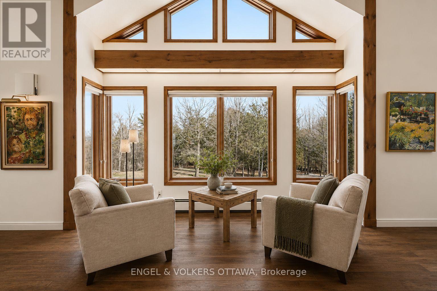 Virtually staged with hardwood (estimate on file) - 4637 Northwoods Drive, Ottawa, ON - Indoor Photo Showing Living Room