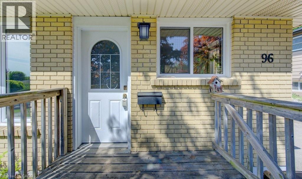 Brick exterior featuring a white arched-window entry door - 96 Scott Road, Cambridge, ON - Outdoor With Deck Patio Veranda With Exterior