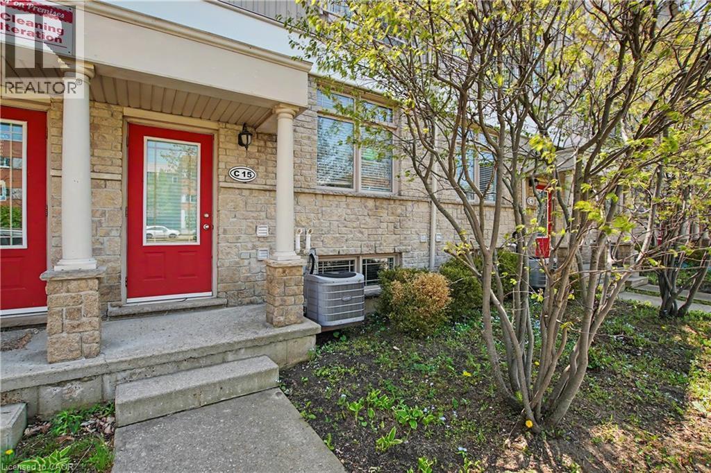 Stone facade entryway featuring a red door with a glass insert - 619 Wild Ginger Avenue Unit# C16, Waterloo, ON - Outdoor