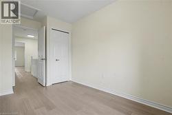 Light wood-finish flooring throughout, complemented by white baseboards and neutral wall tones -