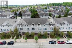 Contemporary townhome exteriors featuring light gray siding and dark gray shingled roofs -