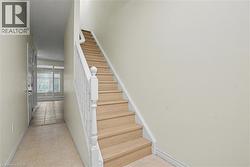Hardwood stairs with white balusters and newel post -