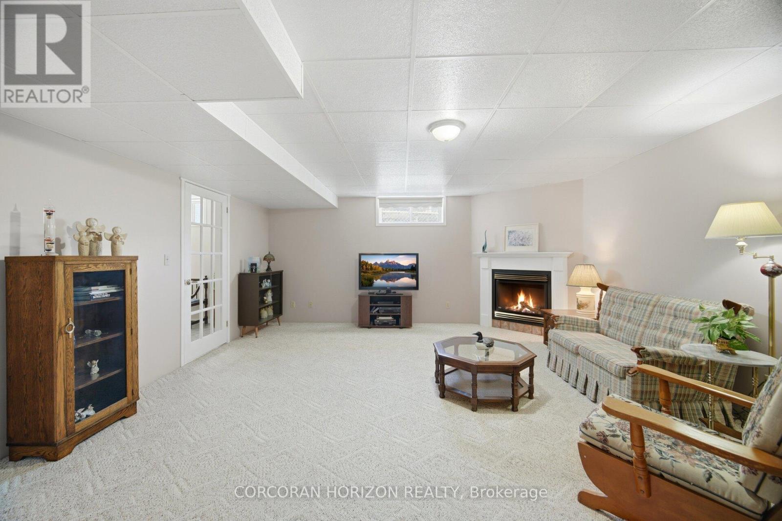 Basement Recreation room with gas fireplace - 71 Grayview Drive, Grey Highlands, ON - Indoor With Fireplace