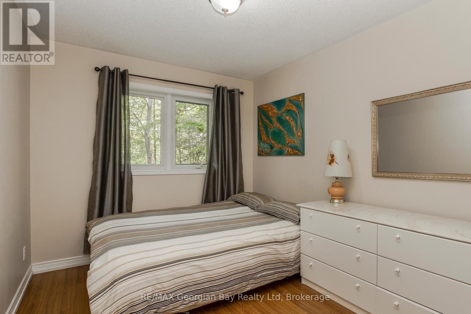 Main Floor Bedroom - 2 Ridout Court, Tiny, ON - Indoor Photo Showing Bedroom