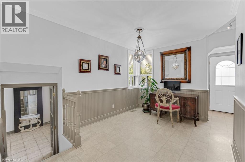 Entryway featuring tile flooring, wainscoting, a prominent window with blinds, and a decorative pendant light fixture - 1 Galbraith Drive, Hamilton, ON - Indoor