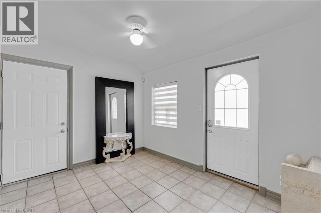Entryway featuring neutral-toned tile flooring and white walls - 1 Galbraith Drive, Hamilton, ON - Indoor Photo Showing Other Room