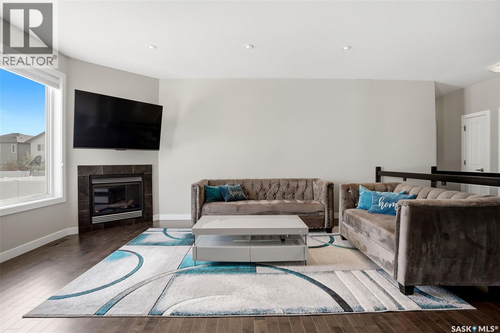 4113 Green Willow Terrace E, Regina, SK - Indoor Photo Showing Living Room With Fireplace