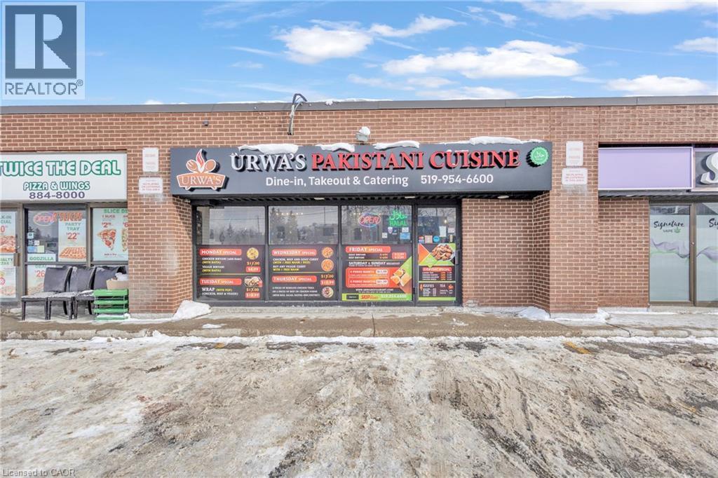 Commercial storefront featuring a brick facade and prominent signage - 402 King Street N, Waterloo, ON