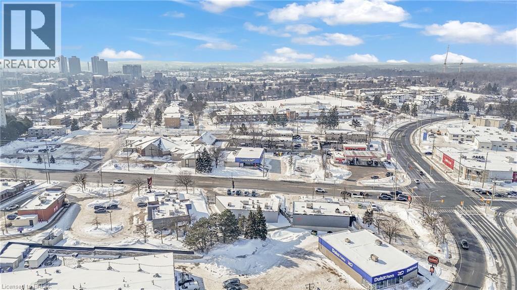 Expansive aerial perspective showcasing a snowy urban landscape with a clear blue sky - 402 King Street N, Waterloo, ON