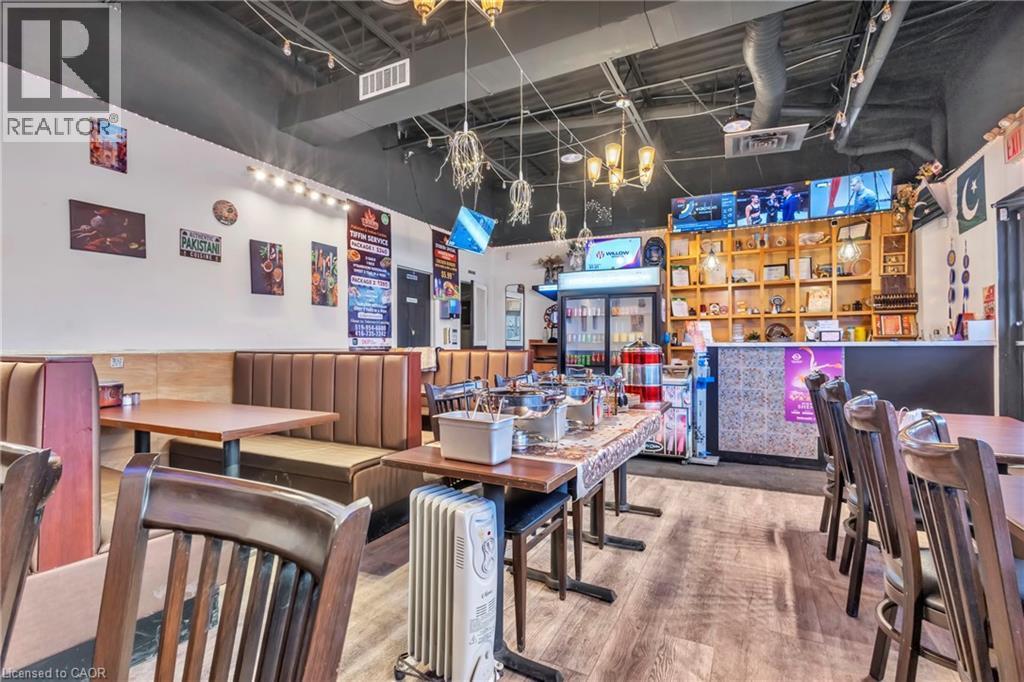 Spacious commercial interior featuring banquette seating and wood-finish flooring - 402 King Street N, Waterloo, ON