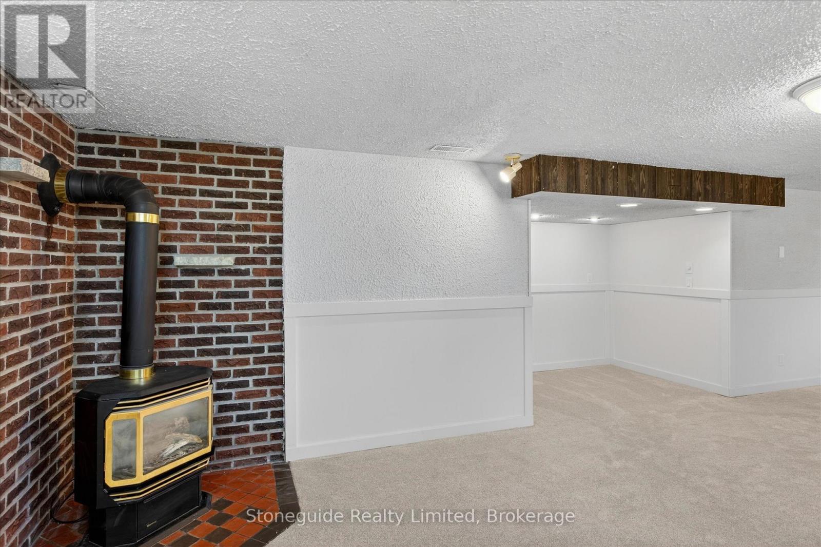 667 Skyline Road, Selwyn, ON - Indoor Photo Showing Other Room With Fireplace