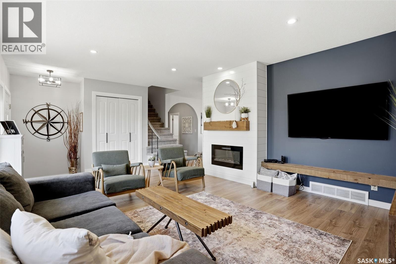 10 Louise Crescent, Regina, SK - Indoor Photo Showing Living Room With Fireplace