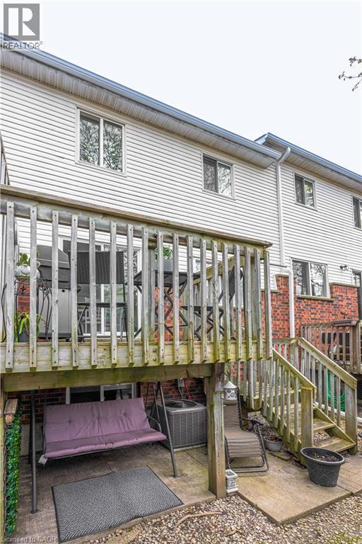 Multi-level deck and patio area featuring wooden railing and steps - 185 Highland Crescent Unit# 2, Kitchener, ON - Outdoor With Deck Patio Veranda