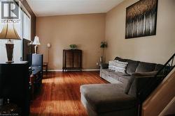Open-concept living space with wood-finish flooring -