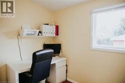Room featuring a single-pane window with white trim, a built-in white floating shelf, and wood-finish flooring -