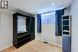 Room featuring light wood-finish flooring and recessed lighting -