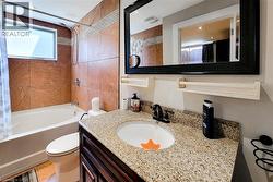 Bathroom featuring a built-in tub and shower combination with full-height tile surround -