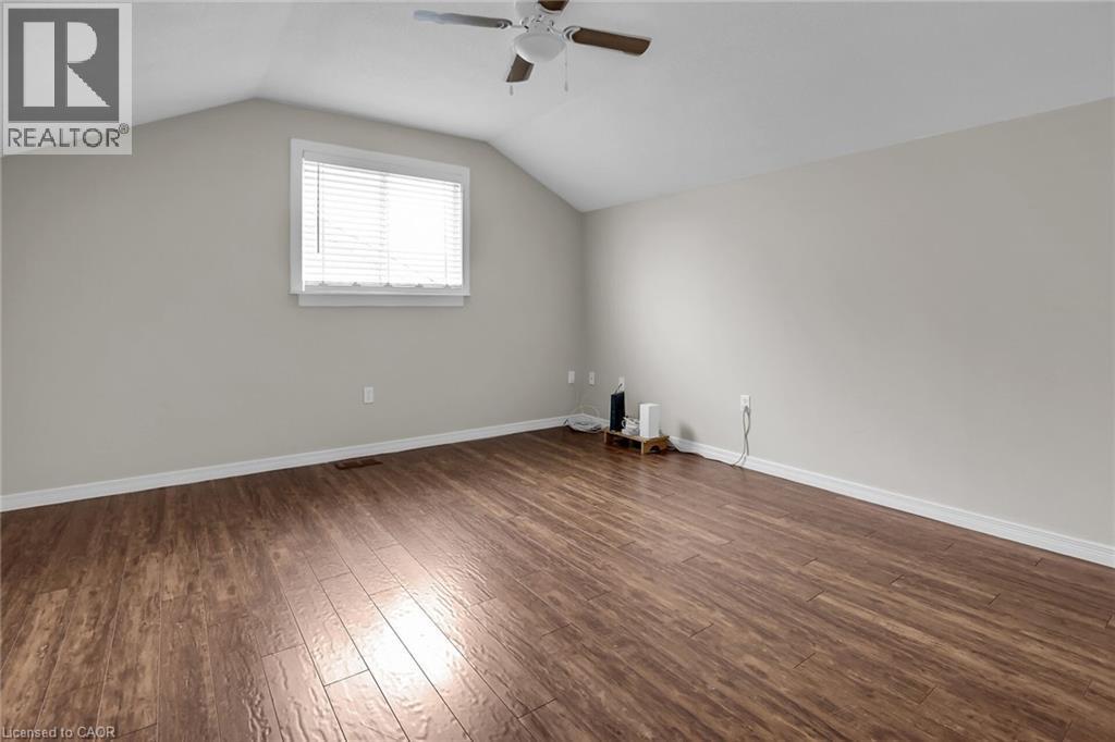 Bedroom with ceiling fan, dark wood flooring, and vaulted ceiling - 4432 Dennis Avenue, Beamsville, ON - Indoor Photo Showing Other Room