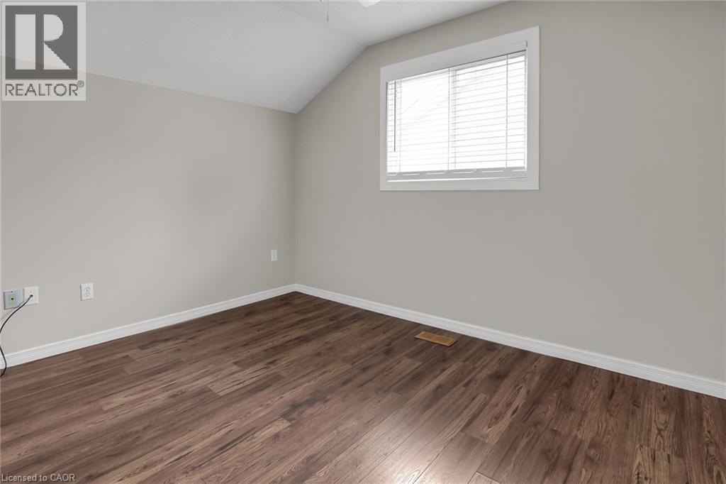 Second Floor with dark wood-style floors, lofted ceiling, and a ceiling fan - 4432 Dennis Avenue, Beamsville, ON - Indoor Photo Showing Other Room