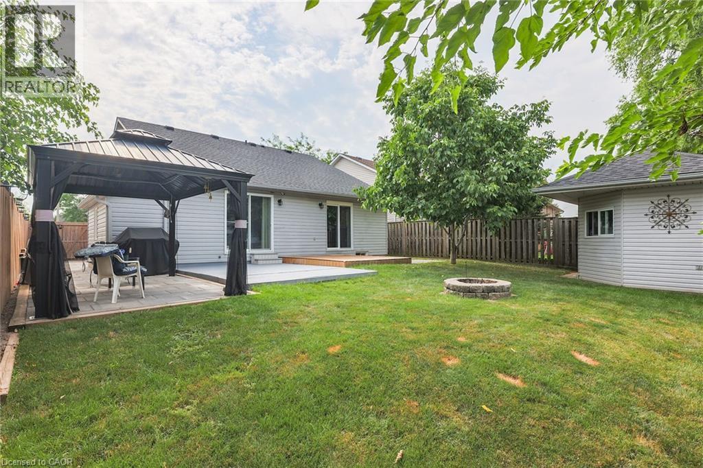 Fenced backyard featuring a fire pit, a patio, and a gazebo - 4432 Dennis Avenue, Beamsville, ON - Outdoor With Exterior