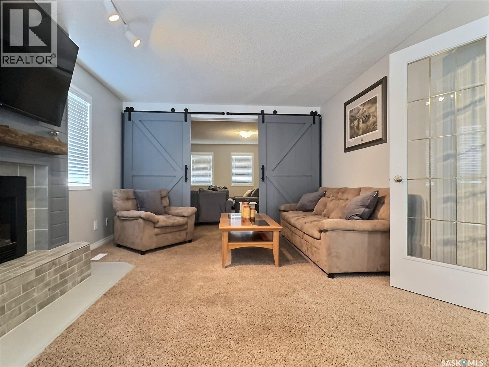 419 Clasky Drive, Estevan, SK - Indoor Photo Showing Living Room With Fireplace
