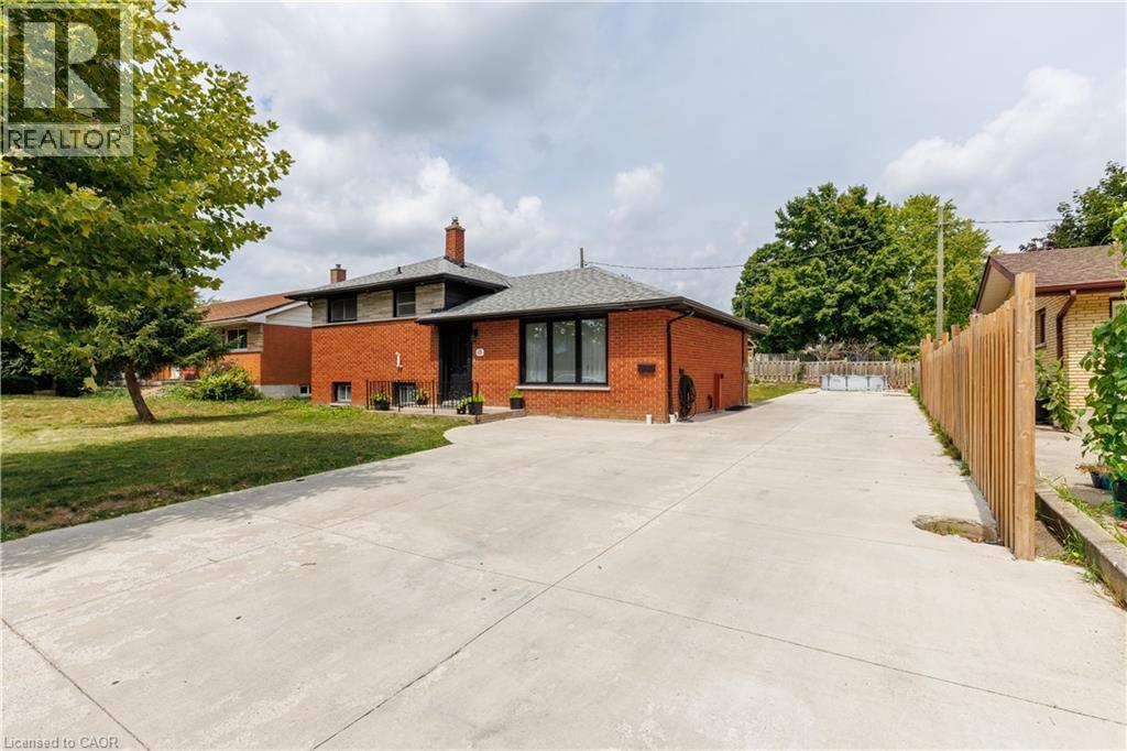 Brick exterior featuring black-framed windows and a dark shingled roof - 18 Silverdale Crescent, London, ON - Outdoor