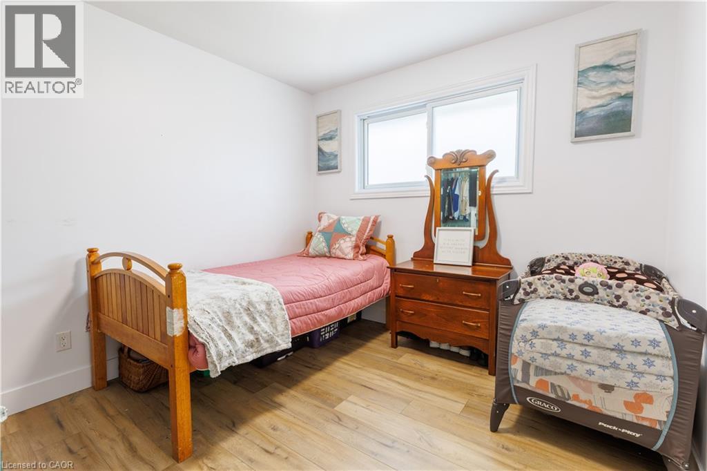 Bright room featuring wood-finish flooring and a white color palette - 18 Silverdale Crescent, London, ON - Indoor Photo Showing Bedroom