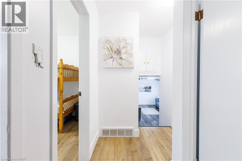Hallway featuring wood-finish flooring, white walls, and built-in overhead cabinetry - 18 Silverdale Crescent, London, ON - Indoor Photo Showing Other Room
