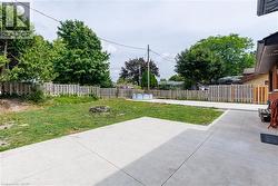 Expansive concrete patio with a grass lawn area -