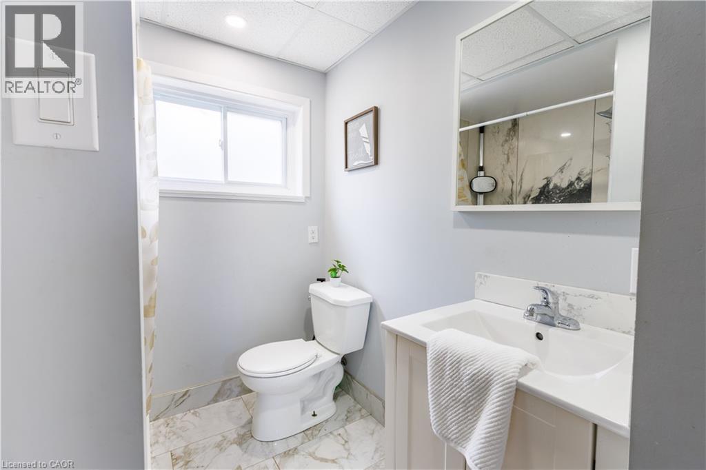 Bathroom featuring a single window, recessed lighting, and a white vanity with an integrated sink - 18 Silverdale Crescent, London, ON - Indoor Photo Showing Bathroom