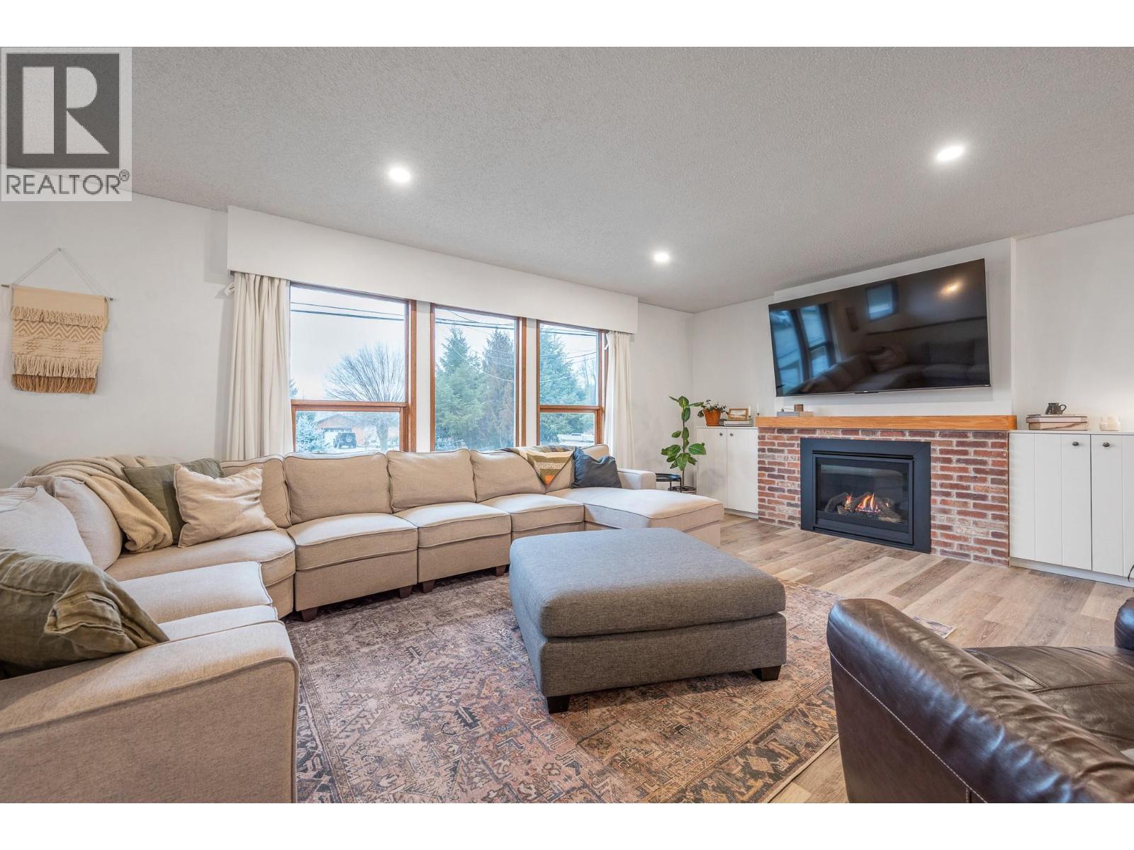 Main Home - Living Room - 302 Bass Avenue, Enderby, BC - Indoor Photo Showing Living Room With Fireplace