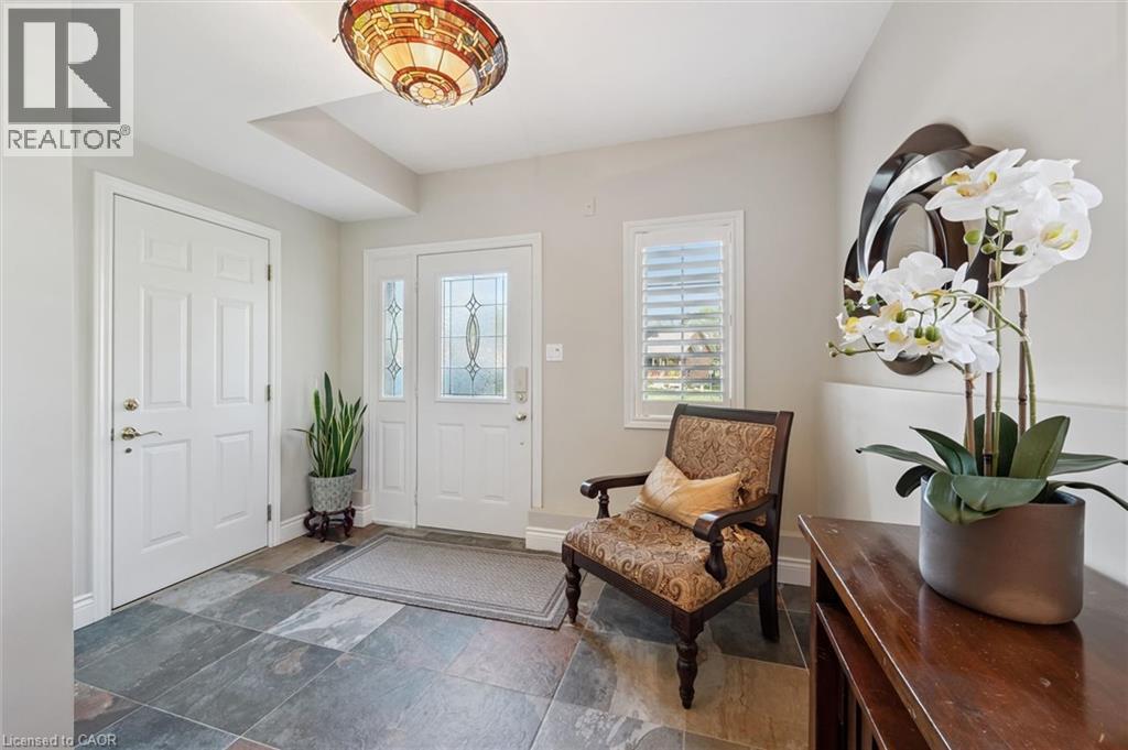Entryway featuring slate tile flooring, a white paneled door, and a white front door with decorative glass inserts and a sidelight - 20 Bonniewood Drive, Drayton, ON - Indoor Photo Showing Other Room