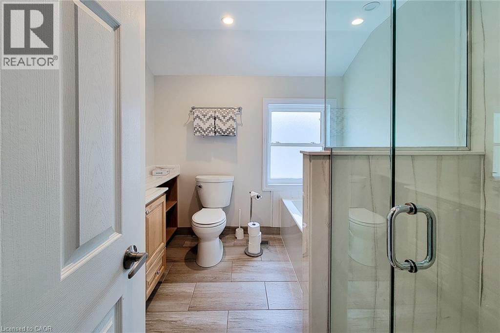 Shower enclosure with clear glass door and chrome hardware - 319 King Street W, Dundas, ON - Indoor Photo Showing Bathroom