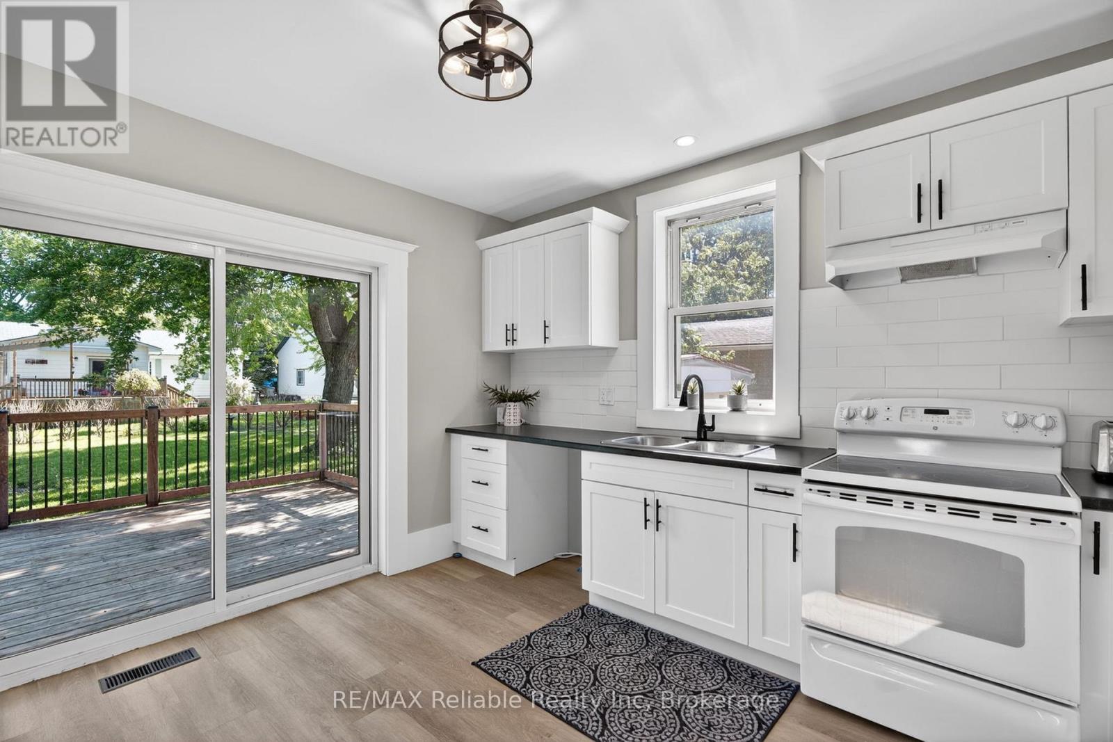 walk out to back deck - 185 Trafalgar Street, West Perth (Mitchell), ON - Indoor Photo Showing Kitchen With Double Sink