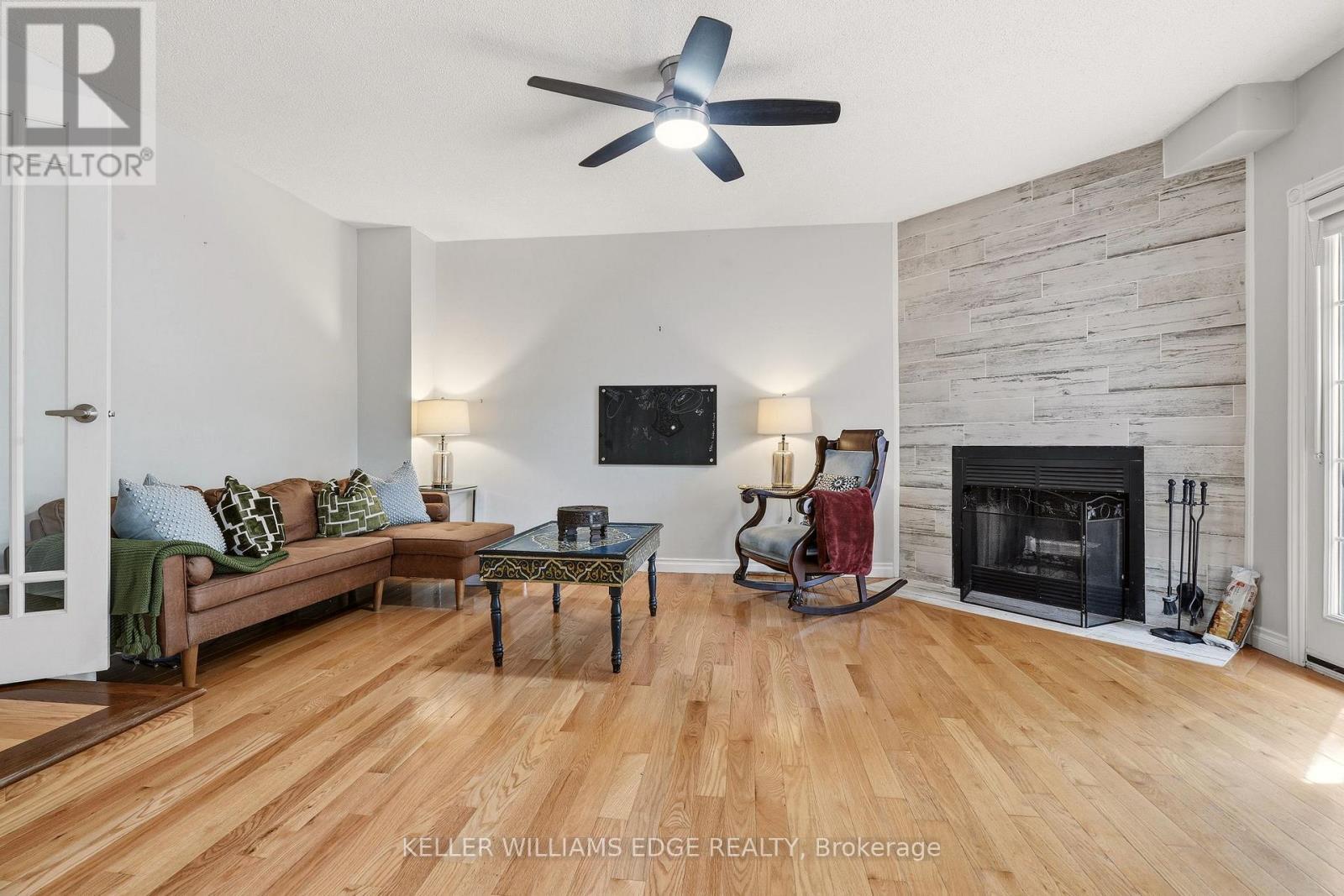 Bright family room w/ fireplace & deck/pool access - 149 Cove Crescent, Hamilton, ON - Indoor Photo Showing Living Room With Fireplace