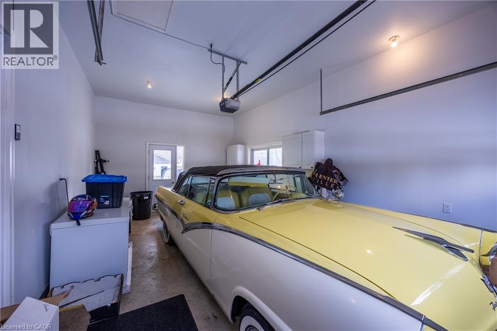 Spacious garage featuring white walls and a light concrete floor - 514 Fishers Glen Road, Vittoria, ON - Indoor Photo Showing Garage