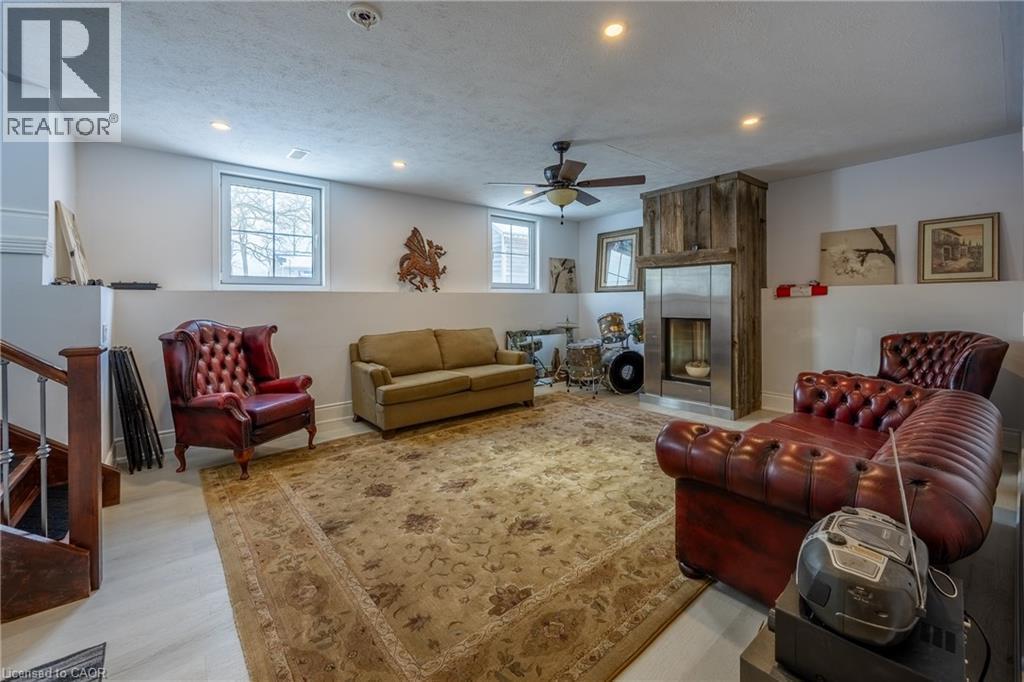 Spacious lower-level living area featuring light-toned flooring and multiple windows - 514 Fishers Glen Road, Vittoria, ON - Indoor Photo Showing Other Room