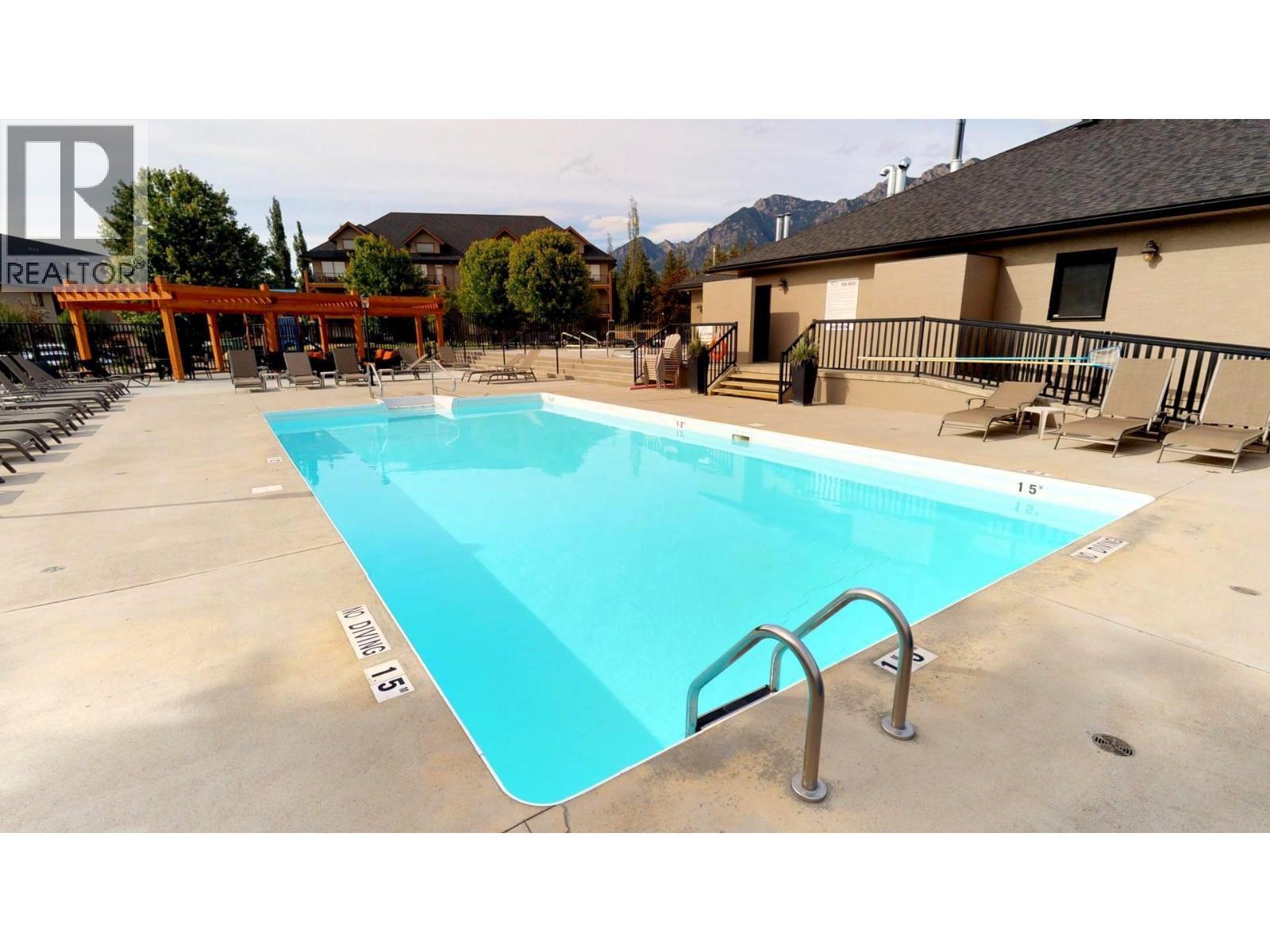 400 Bighorn Boulevard Unit# 416 K1, Radium Hot Springs, BC - Outdoor With In Ground Pool With Deck Patio Veranda